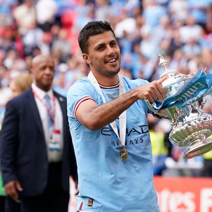 Manchester City's Rodrigo holds the winners trophy as he celebrates winning the English FA Cup final soccer match between Manchester City and Manchester United at Wembley Stadium in London, Saturday, June 3, 2023. Manchester City won 2-1. (AP Photo/Dave Thompson)