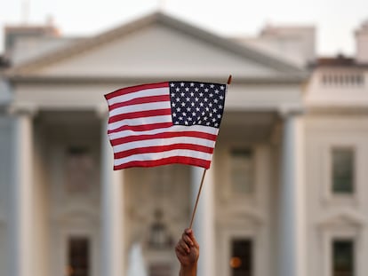 FILE - In this Sept. 2017 file photo, a flag is waved outside the White House, in Washington.  The Trump administration announced Friday that it was curbing legal immigration from six additional countries that officials said did not meet security screening standards, as part of an election-year push to further restrict immigration. Officials said immigrants from Kyrgyzstan, Myanmar, Eritrea, Nigeria, Sudan and Tanzania will face new restrictions in obtaining certain visas to come to the United States. But it is not a total travel ban, unlike President Donald Trump’s earlier effort that generated outrage around the world for unfairly targeting Muslims. (AP Photo/Carolyn Kaster)